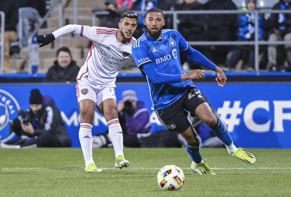 Orlando City's Martin Ojeda, left, and CF Montreal's George Campbell, right, watch the ball during second-half MLS soccer match action in Montreal, Saturday, April 20, 2024. (Graham Hughes/The Canadian Press via AP)