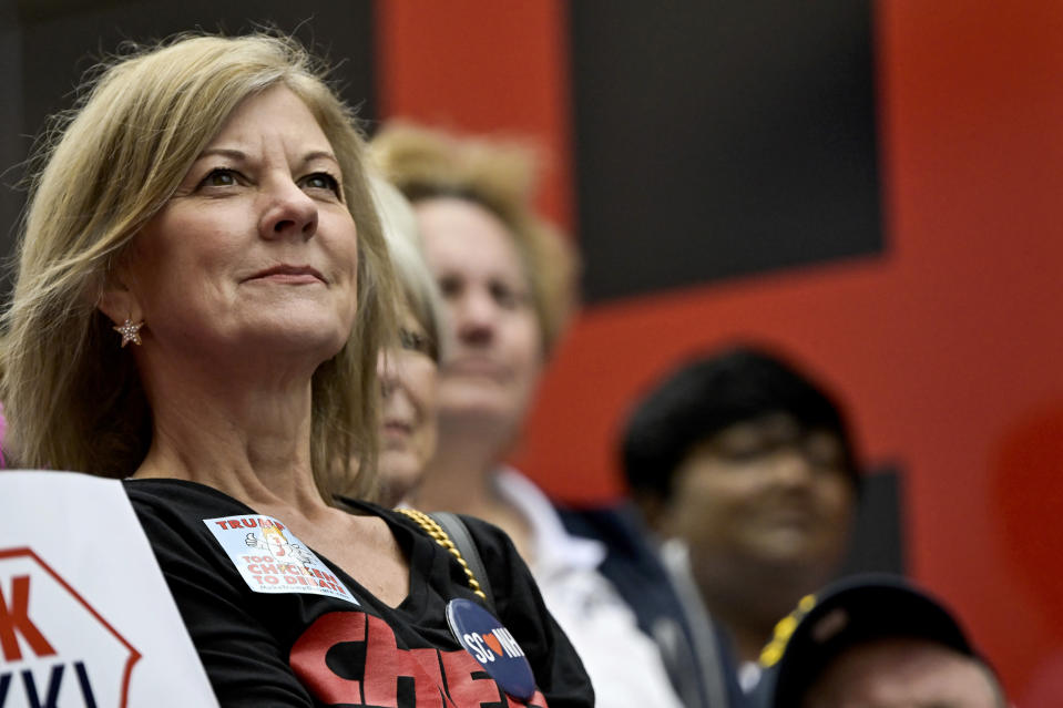 An attendee wearing a pin that reads "Trump Too Chicken To Debate," looks on as Republican presidential candidate former UN Ambassador Nikki Haley speaks at a campaign event in Newberry, S.C., Saturday, Feb. 10, 2024. (AP Photo/Matt Kelley)