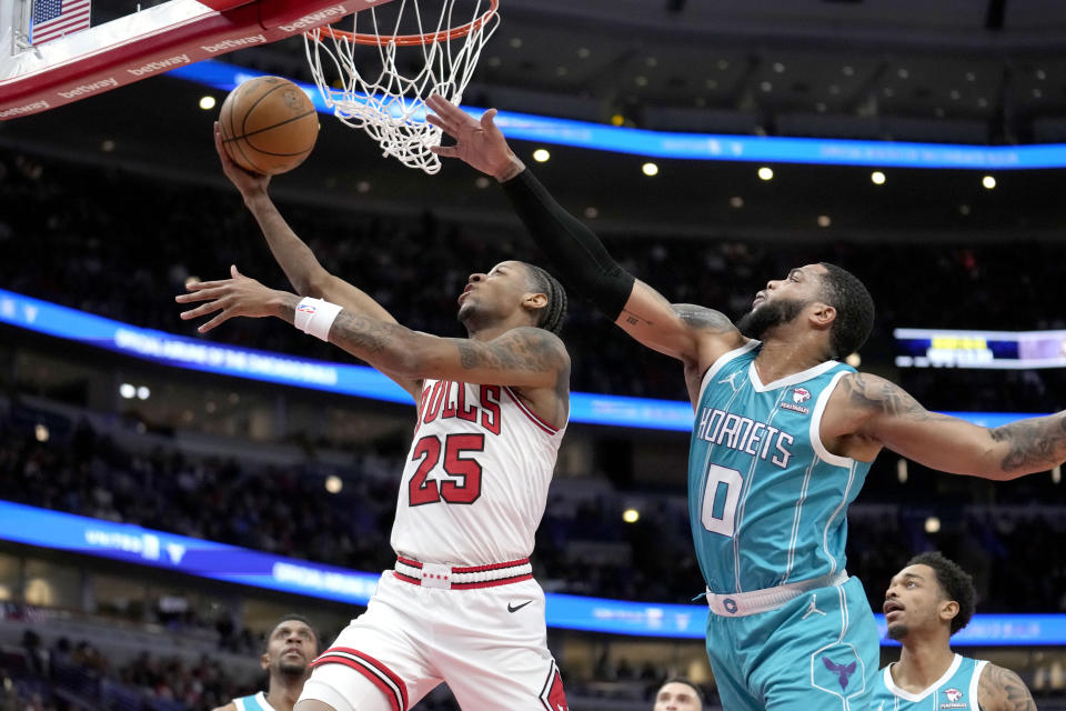 Chicago Bulls' Dalen Terry (25) drives to the basket past Charlotte Hornets' Miles Bridges during the first half of an NBA basketball game Friday, Jan. 5, 2024, in Chicago. (AP Photo/Charles Rex Arbogast)