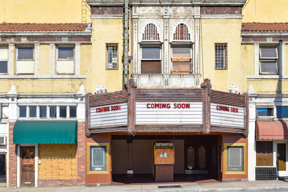 Old theater marquee with "COMING SOON" text, under renovation or awaiting a new release