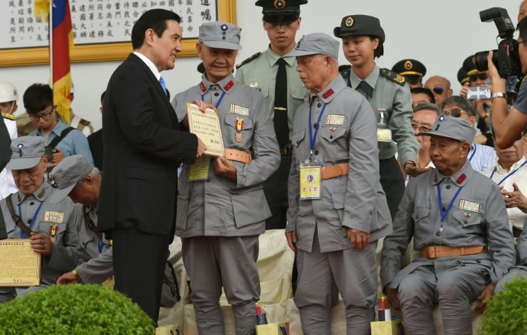 A veteran receives a certificate from President Ma Ying-jeou during the 70th Anniversary of the WWII at the Huko military in northern Hsinchu, Taiwan on July 4, 2015