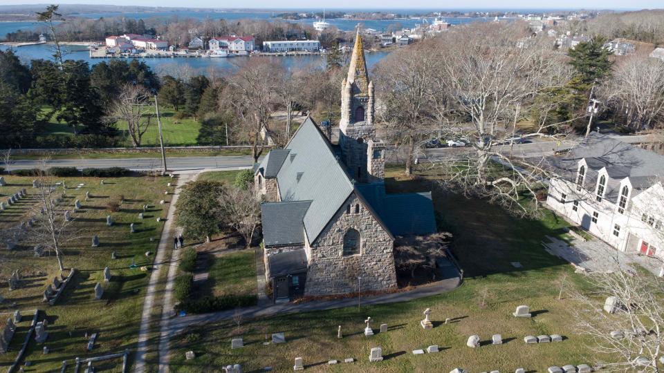 View looking toward Woods Hole harbor from behind the Church of the Messiah in Woods Hole, with their beech tree at right. The venerable old tree has to be taken down because it has beech leaf disease.