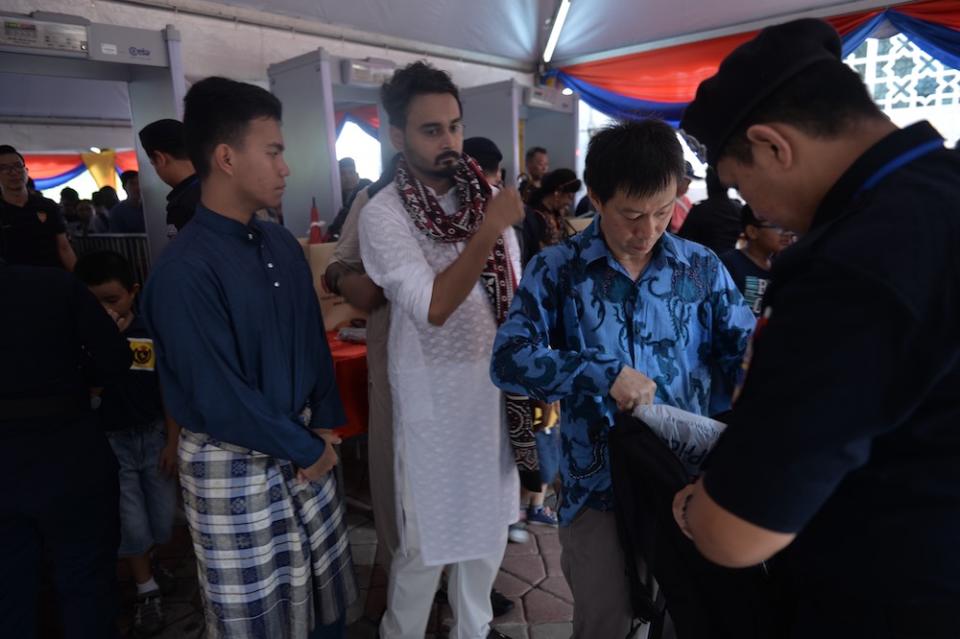 A policeman conducts a bag check during the Prime Minister’s Raya Open House at Seri Perdana in Putrajaya June 5, 2019. — Picture by Mukhriz Hazim