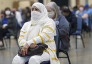 Shagufta Bokharee, of Monroeville, and others wait the required amount of time after receiving the COVID vaccine, Tuesday, March 9, 2021, at the Monroeville Convention Center in Monroeville. Allegheny Health Network (AHN) and the Monroeville Chamber of Commerce partnered to provide the COVID-19 vaccinations to 5,100 area residents. Vaccine recipients will return to the Monroeville Convention Center on Tuesday, March 30th, to receive a second dose of the vaccine. (Pittsburgh Post-Gazette via AP)