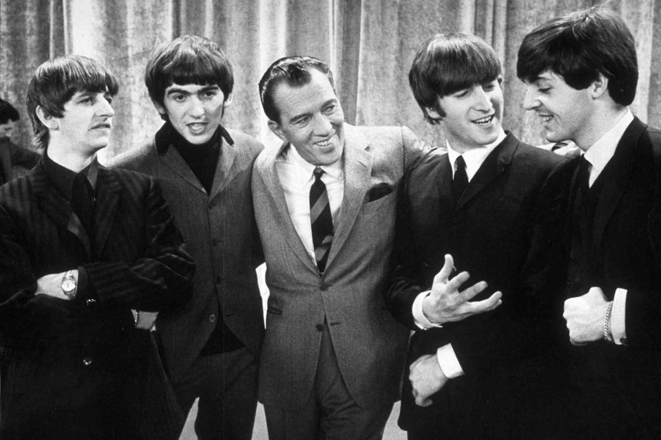 <p>Express Newspapers/Getty</p> The Beatles with Ed Sullivan, February 1964