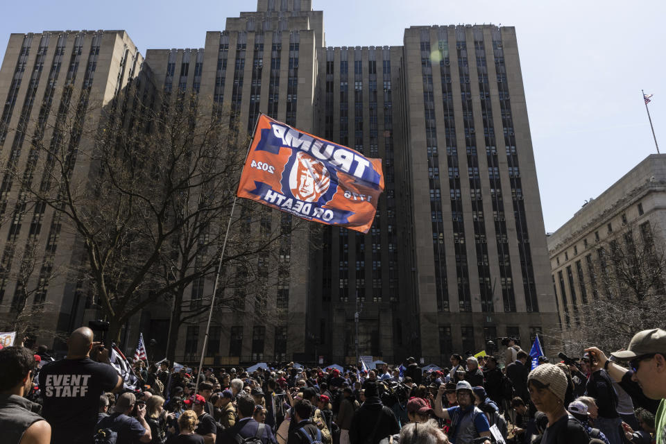 People gather at a protest held in Collect Pond Park across the street from the Manhattan District Attorney's office in New York on Tuesday, April 4, 2023. Former President Donald Trump, who faces multiple election-related investigations, will surrender and be arraigned at Manhattan court Tuesday on criminal charges stemming from 2016 hush money payments. (AP Photo/Stefan Jeremiah)