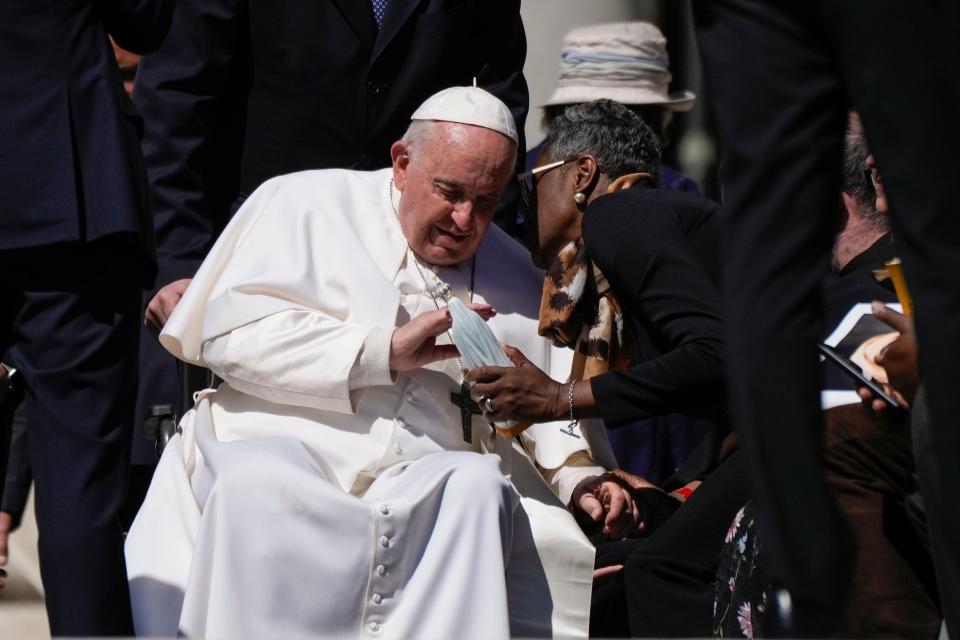 Pope Francis caresses a statuette of the Virgin Mary as he leaves his weekly general audience in St. Peter's Square at the Vatican on April 26, 2023.
