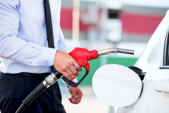 A man refueling a car.