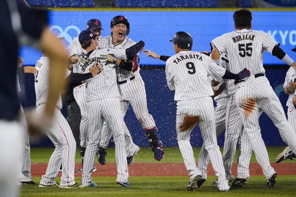 Japan's Takuya Kai, center left, and teammates celebrates their wins after a baseball game against the United States at the 2020 Summer Olympics, Monday, Aug. 2, 2021, in Yokohama, Japan. Japan won 7-6. (AP Photo/Sue Ogrocki)