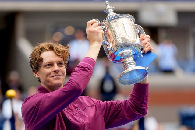 Jannik Sinner holds the US Open trophy aloft