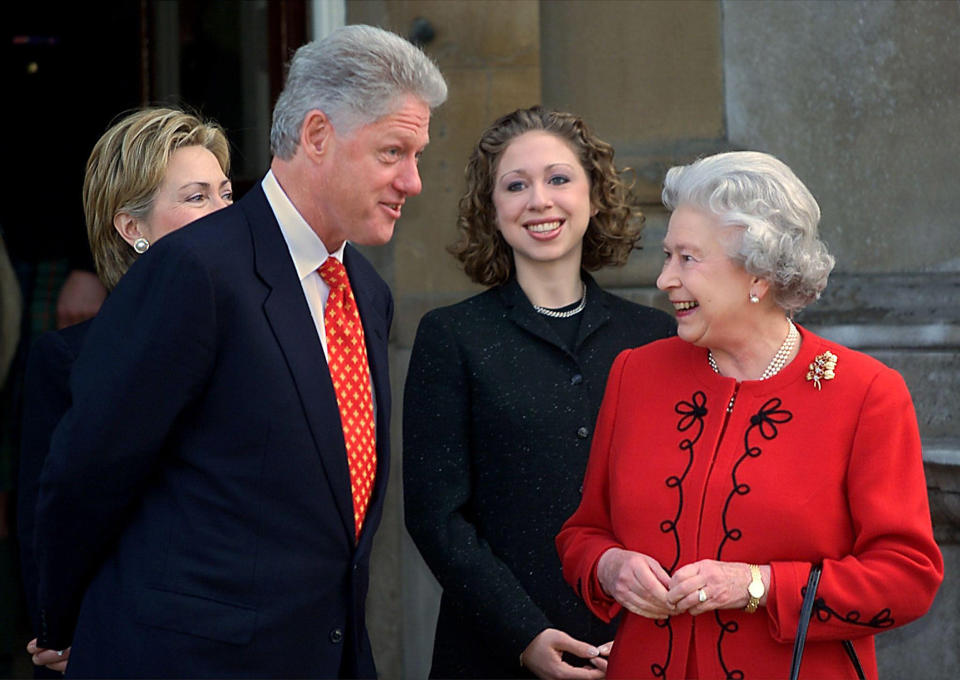 President Bill Clinton talks with Queen Elizabeth II along with the first lady Hillary Clinton and their daughter, Chelsea, at Buckingham Palace on Dec. 14, 2000. (Paul J. Richards / AFP via Getty Images file)