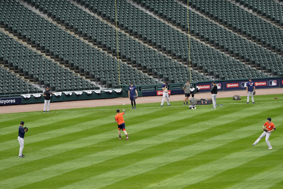 Members of the Houston Astros workout after Game 4 of an ALDS baseball game was postponed due to a forecast of inclement weather Monday, Oct. 11, 2021, in Chicago. The makeup game is scheduled for Tuesday afternoon at Guaranteed Rate Field. (AP Photo/Charles Rex Arbogast)