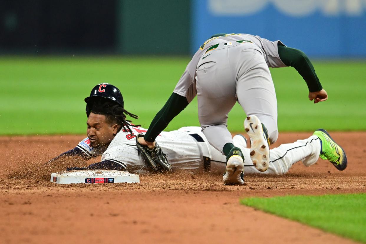 Apr 19, 2024; Cleveland, Ohio, USA; Cleveland Guardians third baseman Jose Ramirez (11) is tagged out trying to stretch a single into a double by Oakland Athletics second baseman Zack Gelof (20) during the fifth inning at Progressive Field. Mandatory Credit: Ken Blaze-USA TODAY Sports