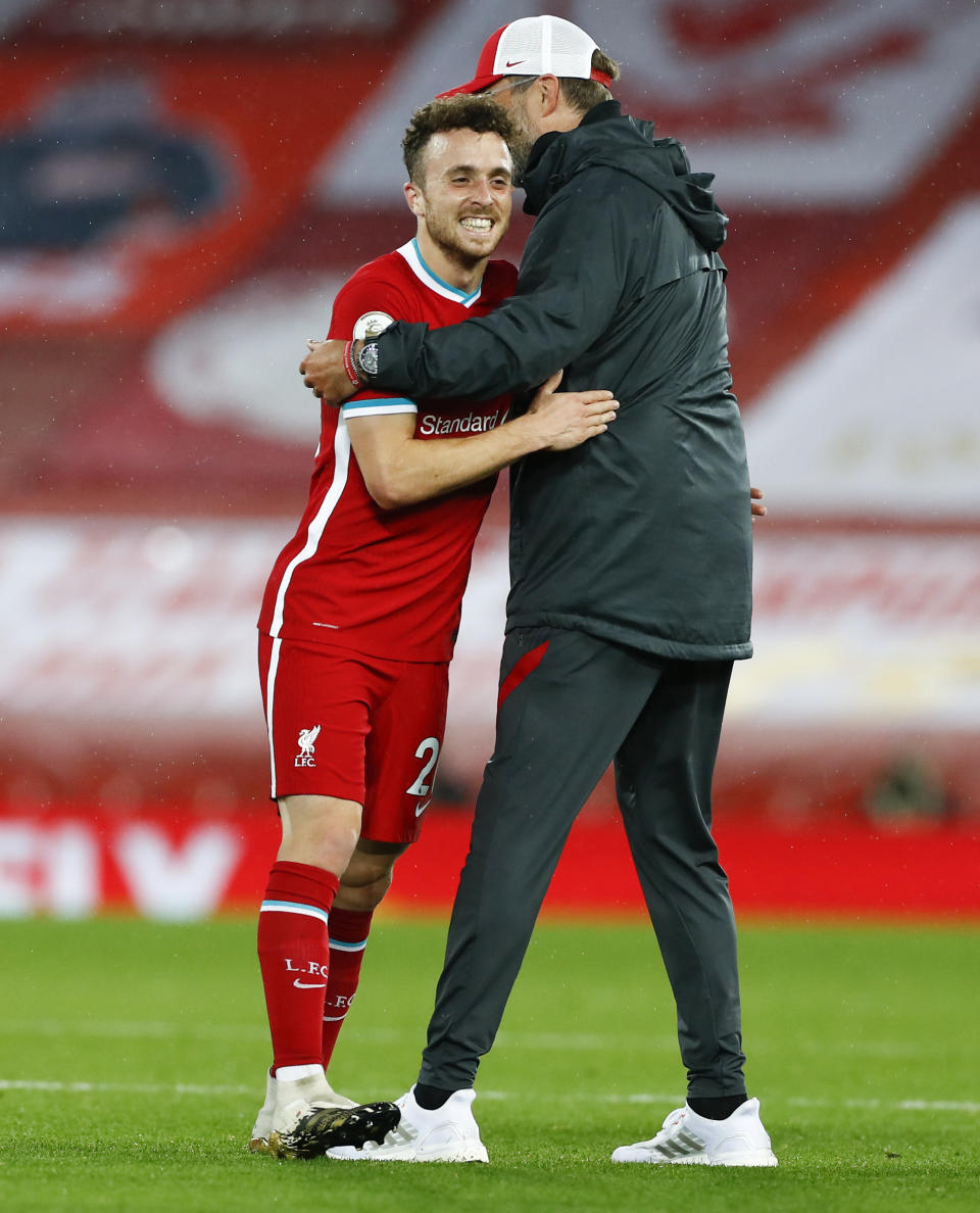 Liverpool's manager Jurgen Klopp embraces Diogo Jota after their English Premier League soccer match between Liverpool and Arsenal at Anfield in Liverpool, England, Monday, Sept. 28, 2020. (Jason Cairnduff/Pool via AP)