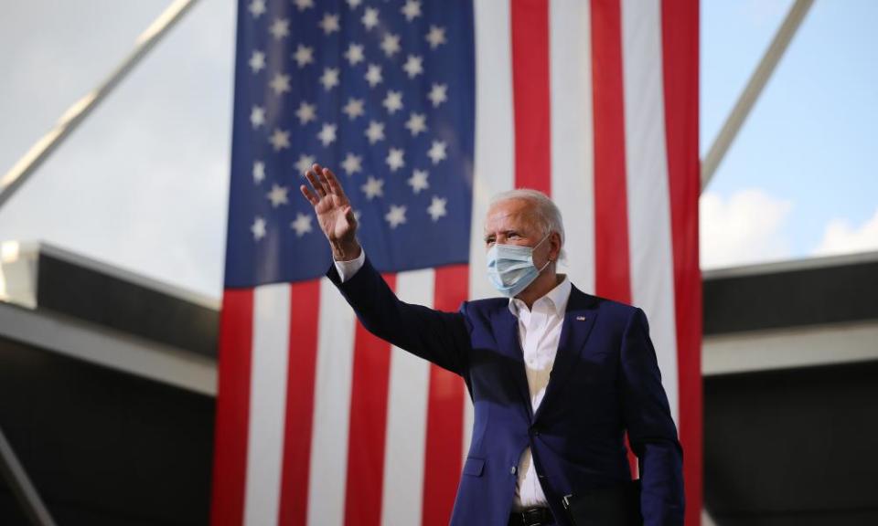 Joe Biden waves to supporters during a drive-in voter mobilisation event at Miramar Regional Park in Florida.