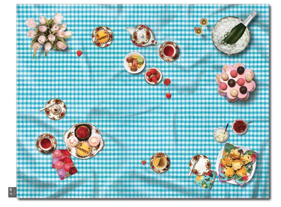 a picnic rug with a tea party set up