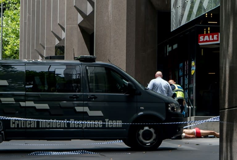 Police arrest a man (bottom-R) who allegedly drove a car into pedestrians in the centre of Melbourne on January 20, 2017