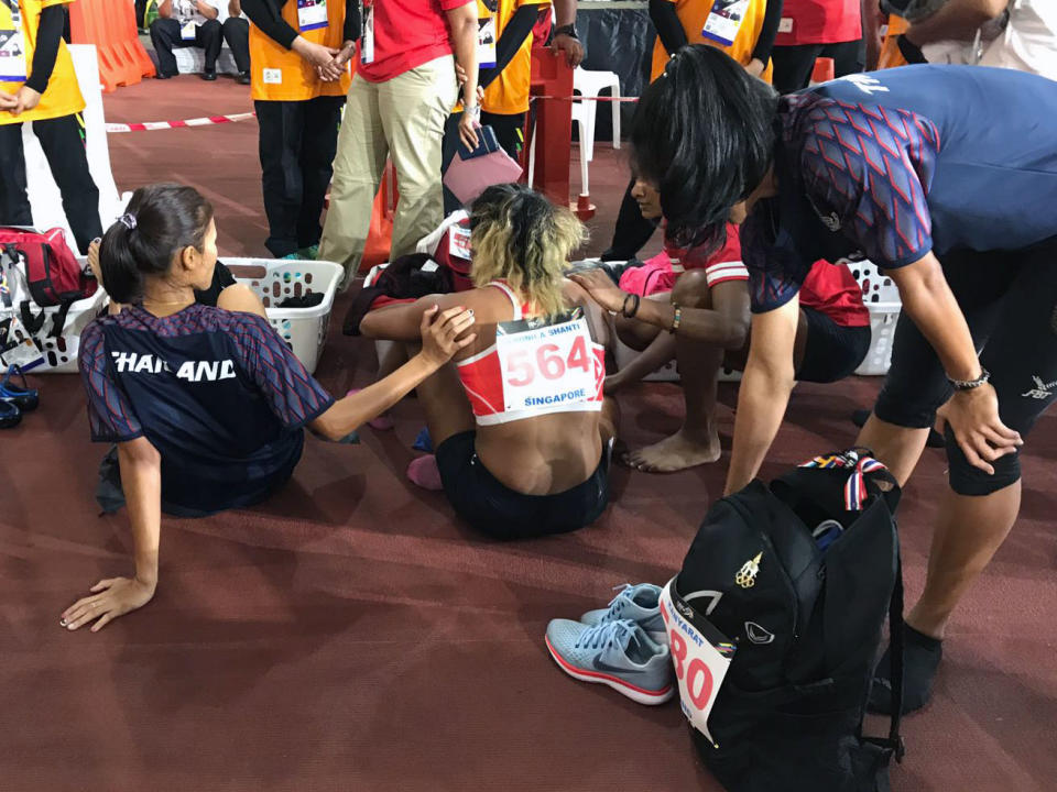 Pereira being consoled by other athletes after the race. (PHOTO: Hannah Teoh / Yahoo News Singapore)