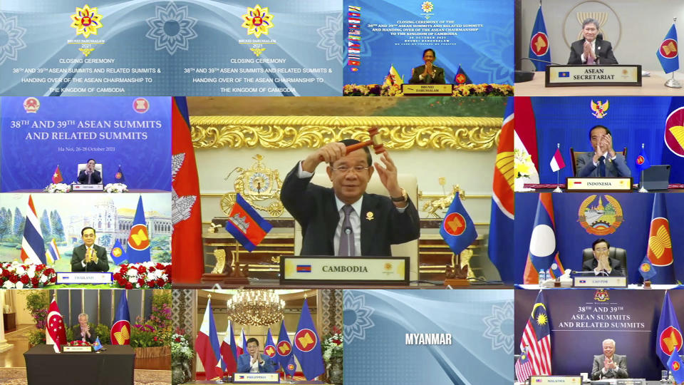 This handout photo released by Brunei ASEAN Summit on Thursday, Oct. 28, 2021, shows Cambodian Prime Minister Hun Sen, center, holding up the gavel for ASEAN chairmanship during the online closing ceremony of the 2021 Association of Southeast Asian Nations (ASEAN) summit, on a live video conference in Brunei's capital Bandar Seri Begawan, Wednesday, Oct. 27, 2021. Southeast Asian leaders began their annual summit without Myanmar on Tuesday amid a diplomatic standoff over the exclusion of the leader of the military-ruled nation from the group's meetings. An empty box of Myanmar is seen at bottom second from right. (Brunei ASEAN Summit via AP)