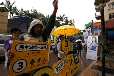 Supporters of Lee Cheuk-yan, a candidate for Hong Kong’s democratic camp, try to canvass votes for a crucial legislative by-election on Sunday at the Mei Foo residential estate, in Hong Kong, China November 25, 2018. REUTERS/James Pomfret