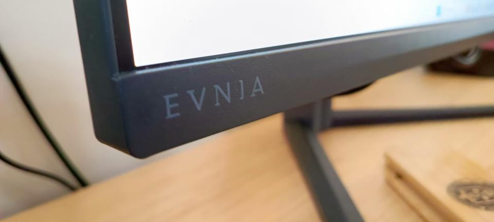 A dark slate Philips Evnia 25M2N5200P monitor on a wooden desk