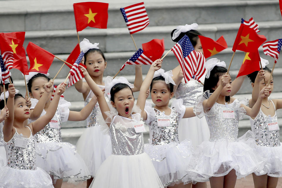 <p>Vietnamese children wave flags before a welcome ceremony of U.S. President Donald Trump at the Presidential Palace in Hanoi, Vietnam, Nov. 12, 2017. (Photo: Luong Thai Linh/AP) </p>