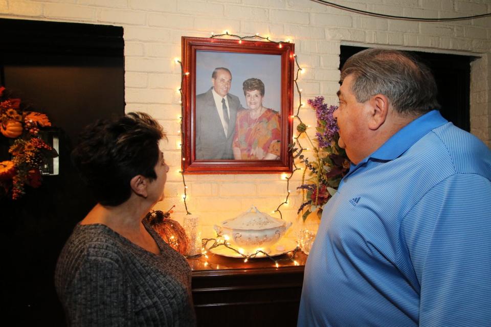 Tony Boffa's children, Donna Boffa Mabee and Anthony Boffa Jr. look at a portrait of their parents that hangs in one of the dining rooms of the family restaurant.