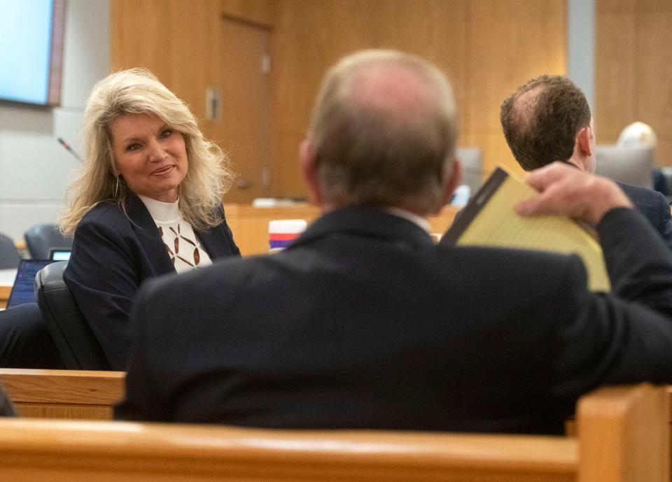 Escambia County Clerk of Court Pam Childers gets a few words of encouragement from her husband before a hearing before Judge William Stone on Monday, Feb. 26, 2024.