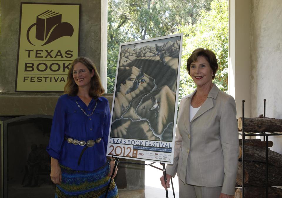 Former first lady Laura Bush, right, and artist Margie Crisp posses with the poster that Crisp made for the 2012 Texas Book festival Wednesday, Sept. 12, 2012, at Bush's home in the Preston Hollow section of Dallas. Bush, who founded the festival when she was first lady of Texas, unveiled this year’s book festival poster for the annual event in Austin. (AP Photo/LM Otero)