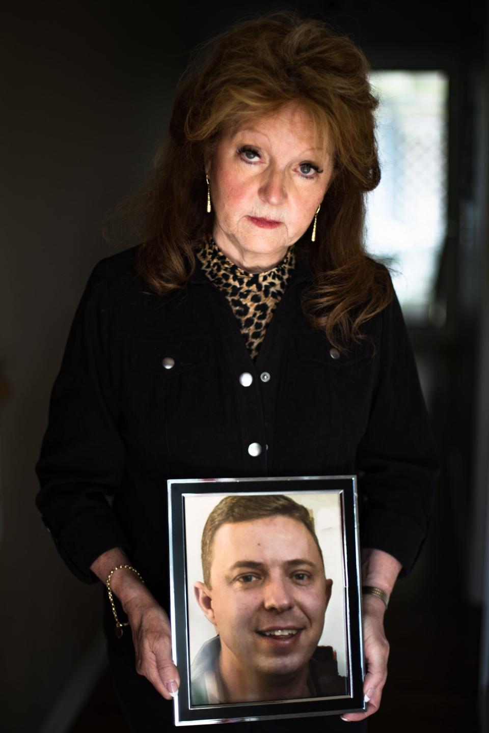 Patricia Telleen, the mother of Jason Telleen, who died after being hit by a bus at the Transfort maintenance and fueling facility in January, displays a photo for a portrait at her Fort Collins home on May 30, 2023.