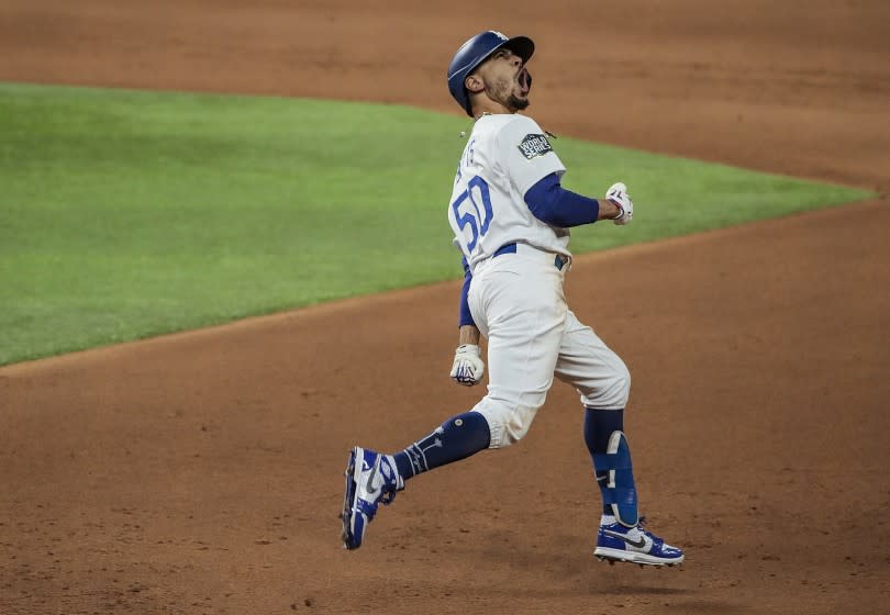 Arlington, Texas, Tuesday, October 27, 2020 Mookie Betts screams out while rounding the bases on an eighth inning homer in game six of the World Series at Globe Life Field. (Robert Gauthier/ Los Angeles Times)