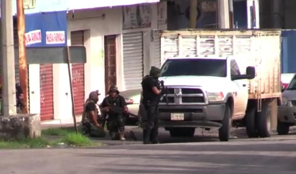 In this AFPTV screen grab armed gunmen take position in a street of Culiacan, capital of jailed kingpin Joaquin "El Chapo" Guzman's home state of Sinaloa, on October 17, 2019. - Heavily armed gunmen in four-by-four trucks fought an intense battle against Mexican security forces Thursday in the city of Culiacan, capital of jailed kingpin Joaquin "El Chapo" Guzman's home state of Sinaloa. (Photo by STR / AFP) (Photo by STR/AFP via Getty Images)