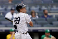 New York Yankees' Gio Urshela hits a go-ahead solo home run off Oakland Athletics relief pitcher Jesus Luzardo in the eighth inning of a baseball game, Saturday, June 19, 2021, in New York. (AP Photo/John Minchillo)