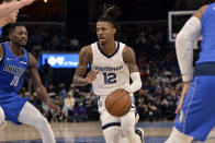 Memphis Grizzlies guard Ja Morant (12) handles the ball against the Dallas Mavericks in the first half of an NBA basketball game Friday, Jan. 14, 2022, in Memphis, Tenn. (AP Photo/Brandon Dill)