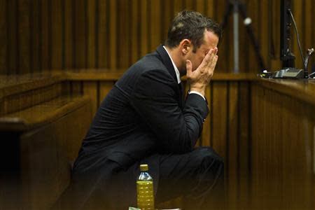 Olympic and Paralympic track star Oscar Pistorius sits in the dock during court proceedings at the North Gauteng High Court in Pretoria, March 13, 2014. REUTERS/Alet Pretorius/Media24/Pool