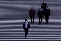 People wearing masks are seen at Lujiazui financial district in Pudong, Shanghai