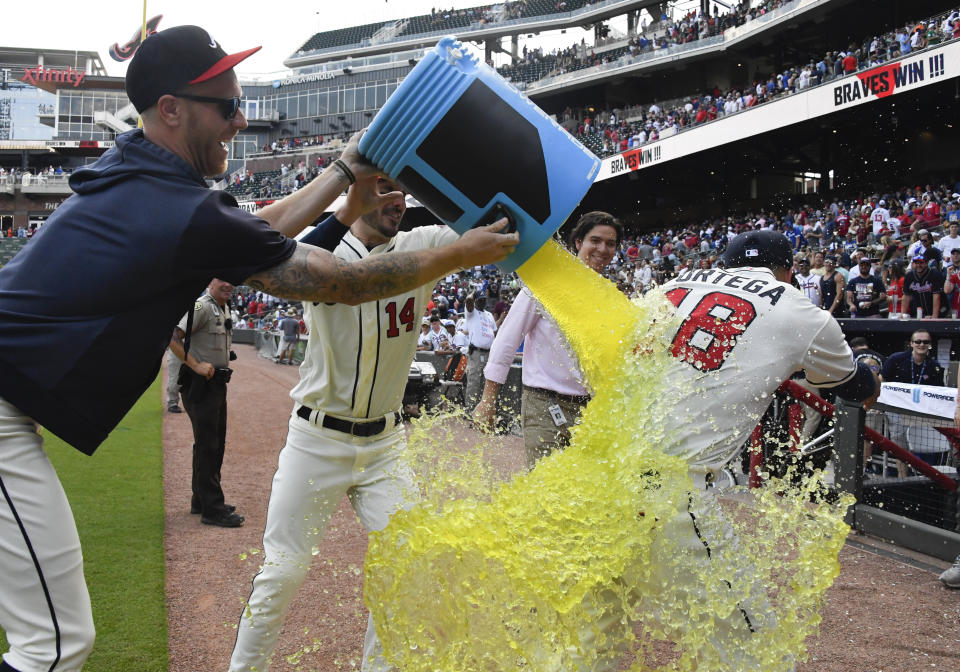 Atlanta Braves' Rafael Ortega is doused by Mike Foltynewicz, and Matt Joyce (14) after a baseball game against the Los Angeles Dodgers, Sunday, Aug. 18, 2019, in Atlanta. The Braves won 5-3. (AP Photo/John Amis)