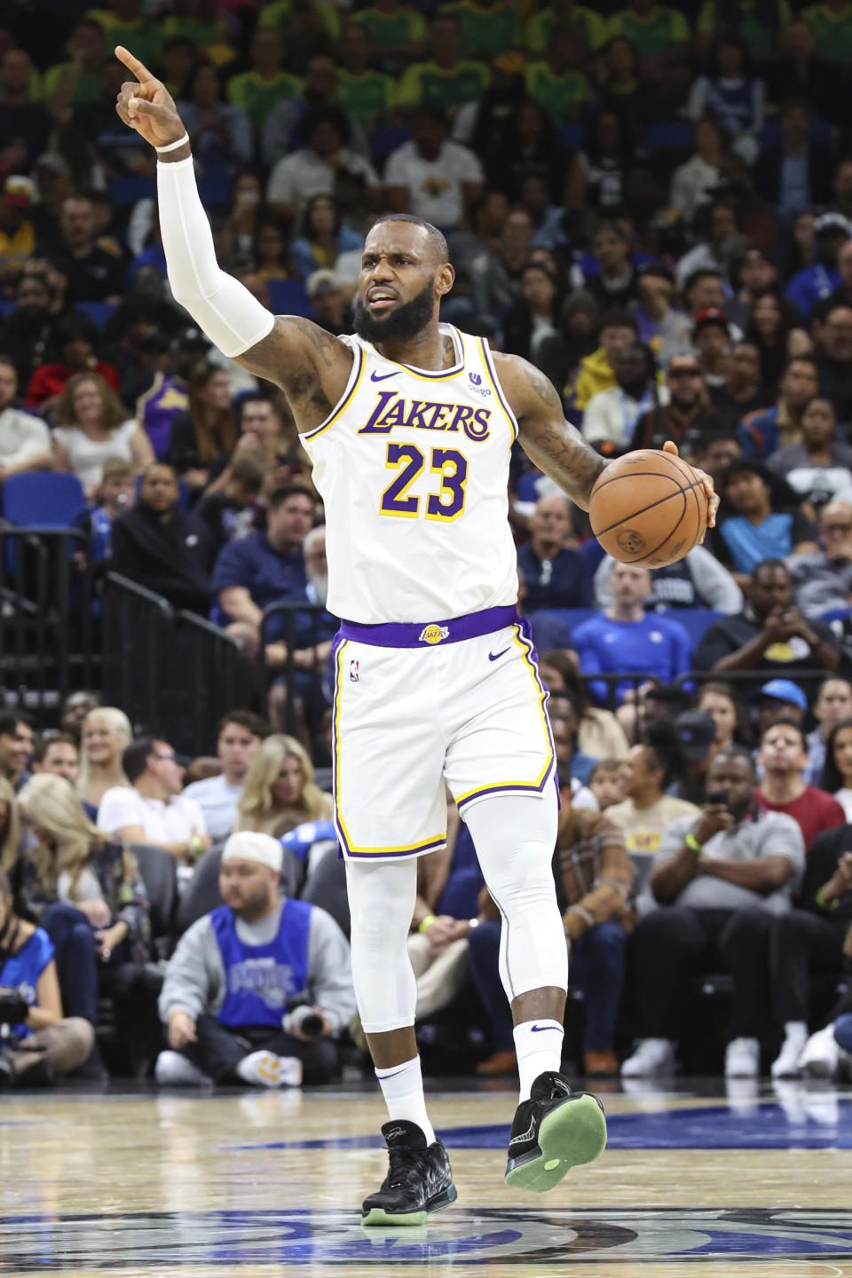 Los Angeles Lakers forward LeBron James signals to teammates during the first half of an NBA basketball game against the Orlando Magic, Saturday, Nov. 4, 2023, in Orlando, Fla. (AP Photo/Gary McCullough)