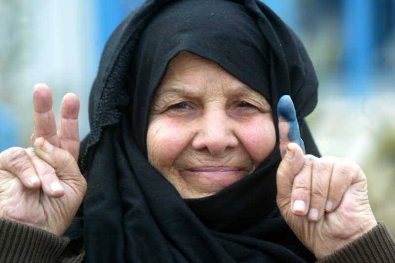 A Palestinian woman shows her finger stained with indelible ink after she cast her vote in the Palestinian elections at a polling station in Rafah in the Gaza Strip on January 25, 2006. The militant Islamic group Hamas, calling for destruction of Israel, scored a stunning victory File Photo by Ismael Mohamad/UPI