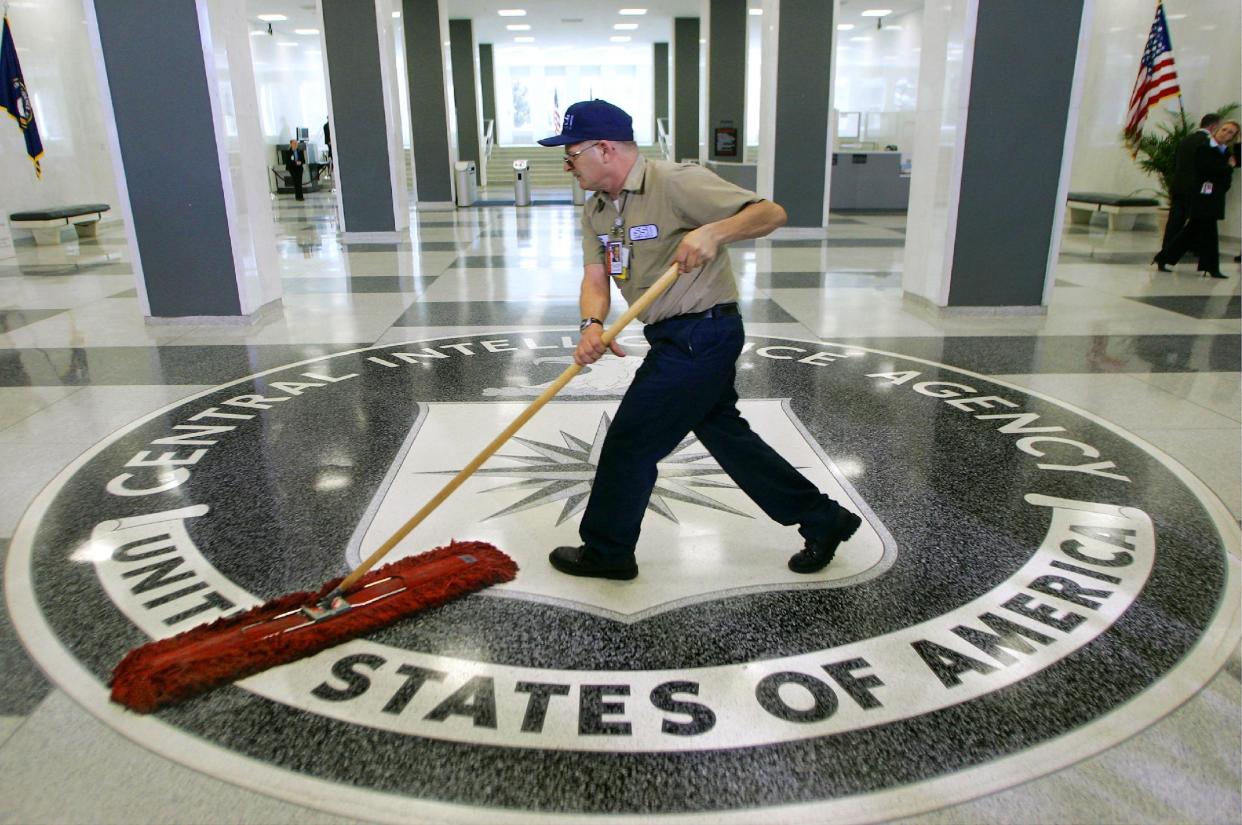 A workman slides a dust mop over the floor at the Central Intelligence Agency headquarters in Langley, Va. (AP Photo/J. Scott Applewhite)