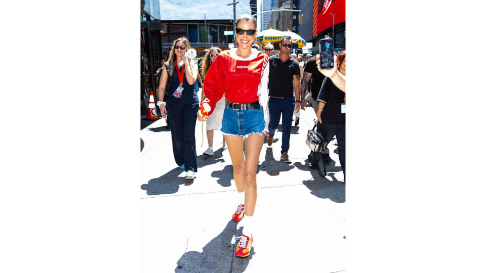 Bella Hadid is seen in Midtown on July 11, 2024 in New York City wearing jorts and red shirt