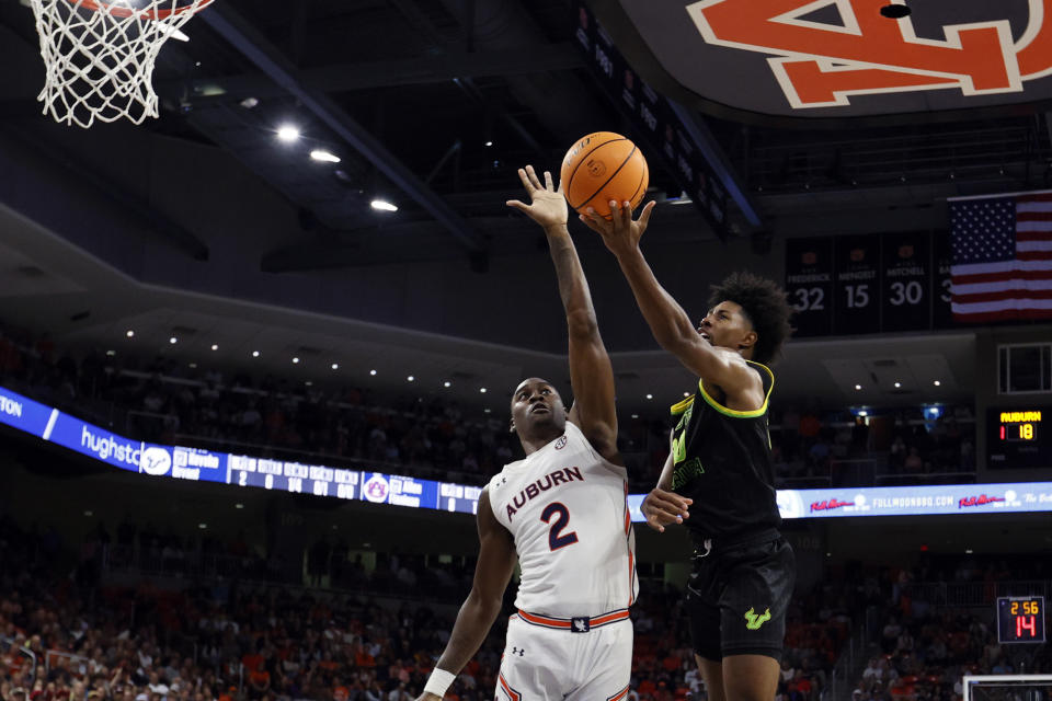 South Florida forward Sam Hines Jr. (20) shoots against Auburn forward Jaylin Williams (2) during the first half of an NCAA college basketball game Friday, Nov. 11, 2022, in Auburn, Ala. (AP Photo/Butch Dill)