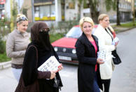 Indira Sinanovic, first Bosnian woman wearing niqab to run in local election in Bosnia, shares promotional material with colleagues in Zavidovici, Bosnia and Herzegovina, September 27, 2016. REUTERS/Dado Ruvic