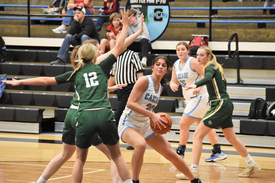 Monrovia defenders close in on Cascade's Sydney Warran during the Bulldogs' rivalry matchup with the Cadets on Dec. 13, 2022.