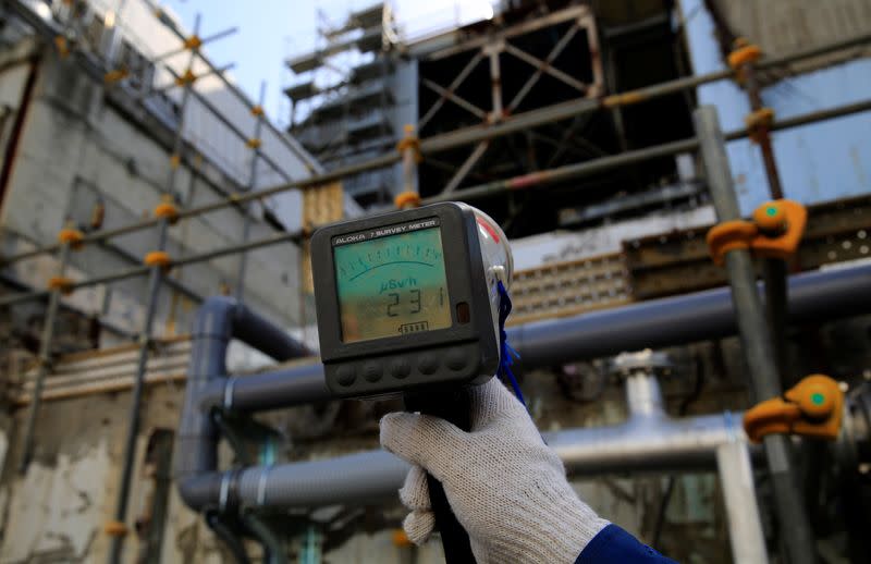 A Geiger counter shows a radiation level of 231 microsieverts per hour near the damaged No. 3 reactor building at the tsunami-crippled Fukushima Daiichi nuclear power plant in Okuma town, Fukushima prefecture