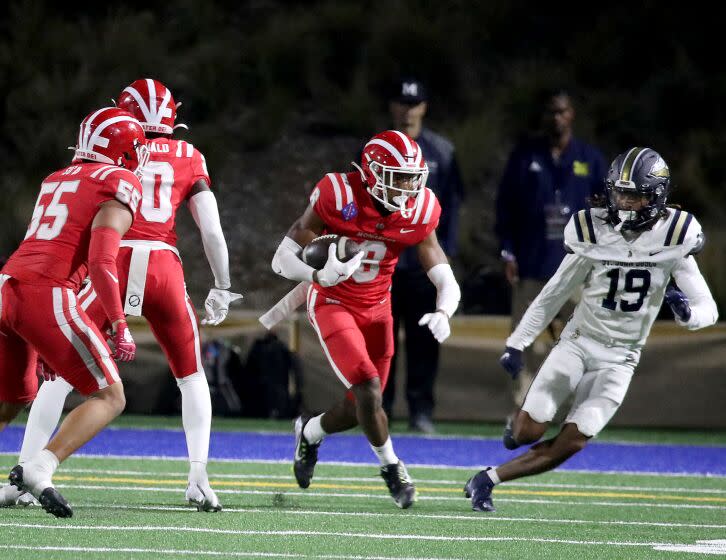 SANTA ANA, CALIF. - OPCT. 7, 2022. Mater Dei quarterback Elijah Brown celebrates after rushing for a touchdown against St.John Boscoat Santa Ana Stadium on Friday night, Oct. 7, 2022. (Luis Sinco / Los Angeles Times)