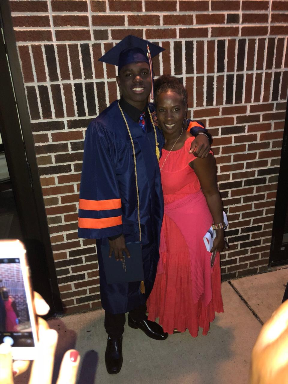 Khalid Dorsey poses for a photo with his mom, Terrell Condrey, after York High's graduation in 2018.