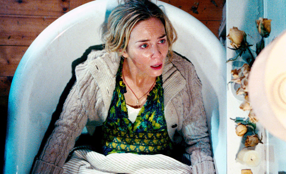 Emily in a bath tub looking scared