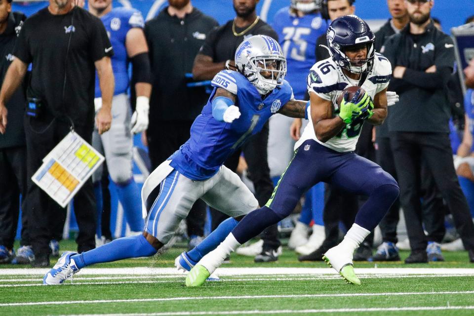 Detroit Lions cornerback Cam Sutton tackles Seattle Seahawks wide receiver Tyler Lockett during the first half at Ford Field in Detroit on Sunday, Sept. 17, 2023.