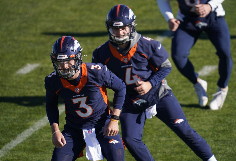 Denver Broncos quarterbacks Drew Lock, front, and Brett Rypien take part in drills during an NFL football practice at the team's heasdquarters Wednesday, Nov. 25, 2020, in Englewood, Colo. (AP Photo/David Zalubowski)